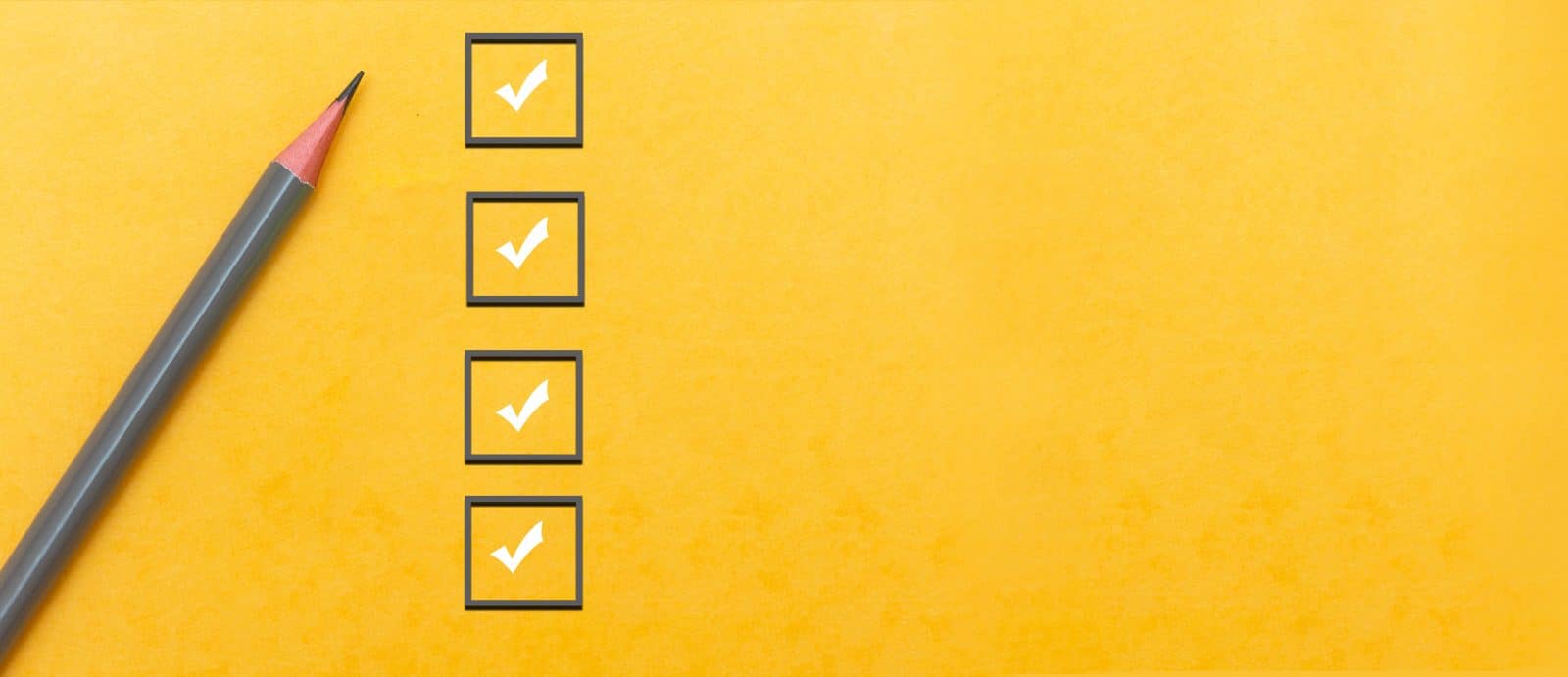 Checklist with pencil on yellow background